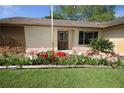 Beautiful home with a decorative front door and colorful flower bed adding curb appeal at 1670 Palmwood Dr, Clearwater, FL 33756