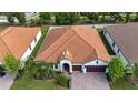 Aerial view of a single-story home showcasing its well-maintained yard and neighborhood at 16913 Clear Cork Dr, Wimauma, FL 33598