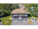 Aerial view of a two-story home featuring a private balcony and a well-kept driveway with ample parking at 1836 Bough Ave # C, Clearwater, FL 33760