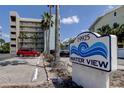Water View condo building features a sign with ocean wave imagery, close to Madeira Beach at 19925 Gulf Boulevard # 502, Indian Shores, FL 33785