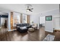 Inviting living room featuring exposed brick wall, ceiling fan, and hardwood floors at 215 Central Ave # 4F, St Petersburg, FL 33701