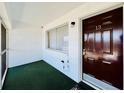 Covered entrance featuring a dark wooden door, window, and neutral color scheme, providing a welcoming feel at 2348 Shelley St # 13, Clearwater, FL 33765