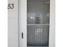 Condo front door with screen, next to house number fifty-three at 2449 Columbia Dr # 53, Clearwater, FL 33763