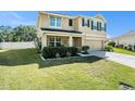 Attractive two-story home with a green lawn and attached two-car garage at 36139 Carriage Pine Ct, Zephyrhills, FL 33541