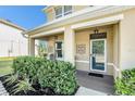 Cozy covered front porch, perfect for relaxing, with decorative accents and a well-kept landscape at 36139 Carriage Pine Ct, Zephyrhills, FL 33541