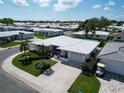An aerial view showcases this home's pristine white roof and lush surrounding community at 3800 101St N Ter # 3800, Pinellas Park, FL 33782