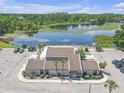Aerial view of the property with a lake, parking and landscaping at 3803 Cortez Cir # C, Tampa, FL 33614