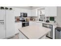 Bright kitchen with white cabinets, stainless steel appliances, and center island at 3885 Timber Ridge Ct, Palm Harbor, FL 34685