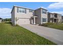 Attractive two-story home boasting tidy landscaping, double-car garage, and contrasting blue shutters and front door at 4114 Dovetail Ln, Palmetto, FL 34221