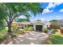 Beautiful single-story home featuring a well-manicured front yard and a spacious driveway at 6154 36Th N Ave, St Petersburg, FL 33710
