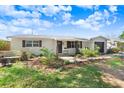 Attractive single-story home with an inviting front yard featuring lush landscaping and mature trees at 6154 36Th N Ave, St Petersburg, FL 33710