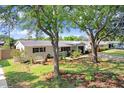 Inviting single-story home with a beautifully landscaped front yard and mature trees at 6154 36Th N Ave, St Petersburg, FL 33710