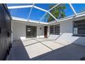 Screened patio area perfect for entertaining or relaxing, with bright light and tiled floors at 6311 Seabreeze Dr, Port Richey, FL 34668