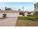 Lovely home with a two-car garage, manicured bushes, and a well-kept lawn at 7094 Fairway Bend Cir # 7094, Sarasota, FL 34243