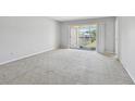 Bright bedroom with neutral carpet, natural light and balcony access at 8703 Bardmoor Blvd # 203, Seminole, FL 33777
