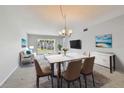 Inviting living room with neutral tones, dining area, plush seating, and view to the outside at 8703 Bardmoor Blvd # 203, Seminole, FL 33777