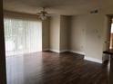 Living room with laminate flooring and sliding glass doors that provide natural light at 10114 Winsford Oak Blvd # 517, Tampa, FL 33624
