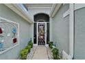 Inviting front entry with decorative accents and a secure, stylish screen door enhancing curb appeal at 1102 Emerald Dunes Dr, Sun City Center, FL 33573