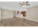 Open-concept floor plan with wood flooring and a view into the kitchen at 1210 Trailwater St, Ruskin, FL 33570