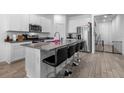 Stylish kitchen boasts a large island with barstools, stainless steel appliances, and modern finishes at 13821 Kinsale St, Riverview, FL 33579