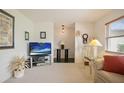 Inviting living room featuring bright walls, carpeted floors, a glass coffee table, and ample natural light at 14006 79Th Ave, Seminole, FL 33776