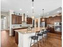 Bright kitchen with granite countertops, stainless steel appliances, and a center island with bar stool seating at 14209 Quintessa Ln, Lithia, FL 33547