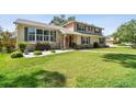Charming two-story home with manicured lawn, stone accents, and inviting front entrance at 14344 83Rd Pl, Seminole, FL 33776