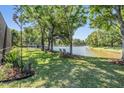Lush backyard with mature trees and serene water views, perfect for relaxation and outdoor enjoyment at 14609 Canopy Dr, Tampa, FL 33626