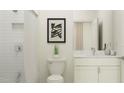 Bright bathroom with white subway tile shower, toilet, and vanity with a marble countertop at 18140 Serene Lake Loop, Lutz, FL 33548