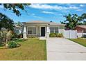 Charming single-story home features a well-manicured lawn and a concrete driveway at 2410 26Th S St, St Petersburg, FL 33712