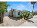 Charming blue home with a brick chimney and mature landscaping at 2610 58Th S St, Gulfport, FL 33707