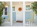 Front porch with chairs, a sunburst decoration, and a welcome mat on a bright day at 2610 58Th S St, Gulfport, FL 33707