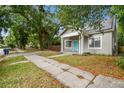 Traditional home featuring a well-kept lawn, a private driveway, and mature trees at 2708 N Mitchell Ave, Tampa, FL 33602