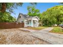 Cozy home with solar panels, a fenced yard, and inviting curb appeal at 2708 N Mitchell Ave, Tampa, FL 33602
