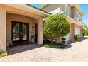 Charming covered entrance with a double door, stone bench, and manicured landscaping at 3 Paradise Ln, Treasure Island, FL 33706