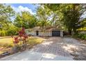 Charming single-story home featuring a well-maintained lawn and mature trees at 3215 Corey Rd, Sarasota, FL 34232