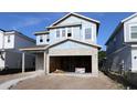 New construction featuring a two-story home with an attached garage, ready for customization and landscaping at 3319 Guanabana Xing, Wesley Chapel, FL 33543
