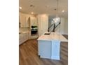 Bright, modern kitchen featuring a large island and stainless steel appliances at 3319 Guanabana Xing, Wesley Chapel, FL 33543