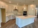Open kitchen with a center island, modern appliances, and stylish finishes at 3319 Guanabana Xing, Wesley Chapel, FL 33543