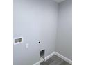 A gray-toned laundry room with laminate floors and washer hookups at 3329 Roxbury Dr, Holiday, FL 34691