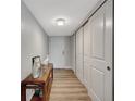 A clean, bright hallway featuring sleek flooring, closet space, and a console table at 400 Island Way # 201, Clearwater Beach, FL 33767