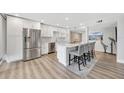 Bright modern kitchen features stainless appliances, quartz counters and breakfast bar with seating at 400 Island Way # 201, Clearwater Beach, FL 33767