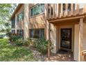 Inviting exterior of home with lush landscaping and an entrance with a glass door at 4027 Davit Dr, New Port Richey, FL 34652
