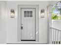 Close-up of the front door with decorative sconces and hardware at 445 33Rd N Ave, St Petersburg, FL 33704