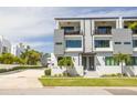 A modern two-story home with a balcony, clean lines, and a well-maintained yard at 4515 W North A St # 8, Tampa, FL 33609