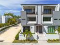 Modern townhome with balconies and a well-kept yard, offering a stylish curb appeal at 4515 W North A St # 8, Tampa, FL 33609