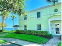 Charming exterior view of the building with manicured lawn and ocean view at 5285 Coquina Key Se Dr # C, St Petersburg, FL 33705
