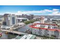 An aerial view showcases the condominium complex overlooking the waterway and downtown skyline at 700 S Harbour Island Blvd # 143, Tampa, FL 33602