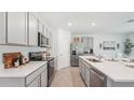 Modern kitchen features stainless steel appliances, white countertops, and ample cabinet space at 7770 Wheat Stone Dr, Zephyrhills, FL 33540
