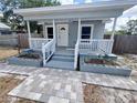 Close-up of the entrance with decorative landscaping adding curb appeal at 804 Whitehurst Rd, Plant City, FL 33563